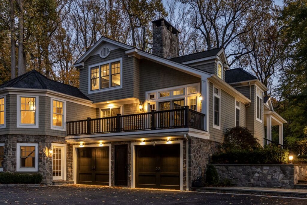 Luxury home with exterior lights highlighting the architecture at dusk, showing a well-maintained lighting system after professional lighting system maintenance.