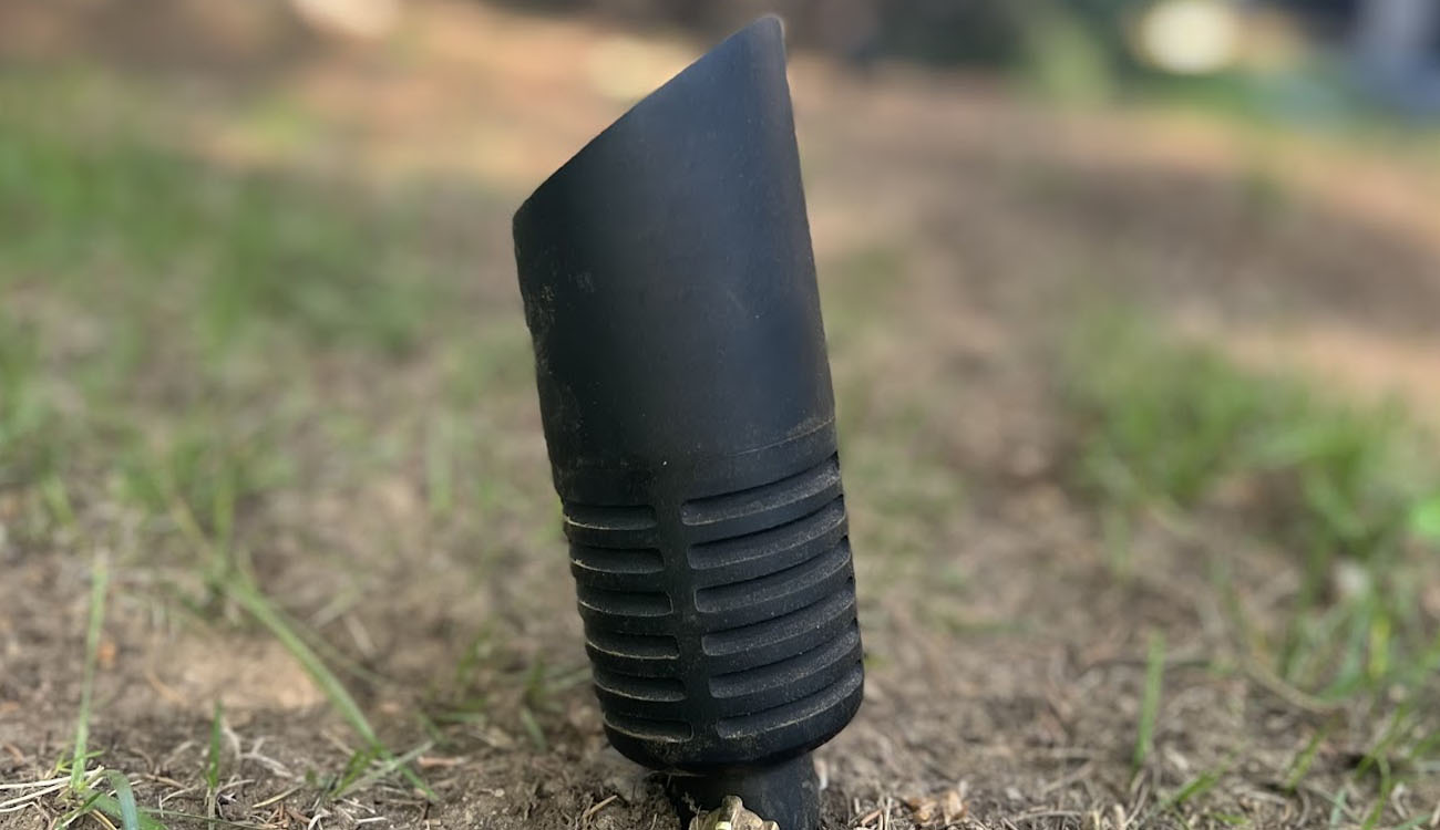 Landscape lighting maintenance service example showing a damaged outdoor lighting fixture in need of repair or replacement.